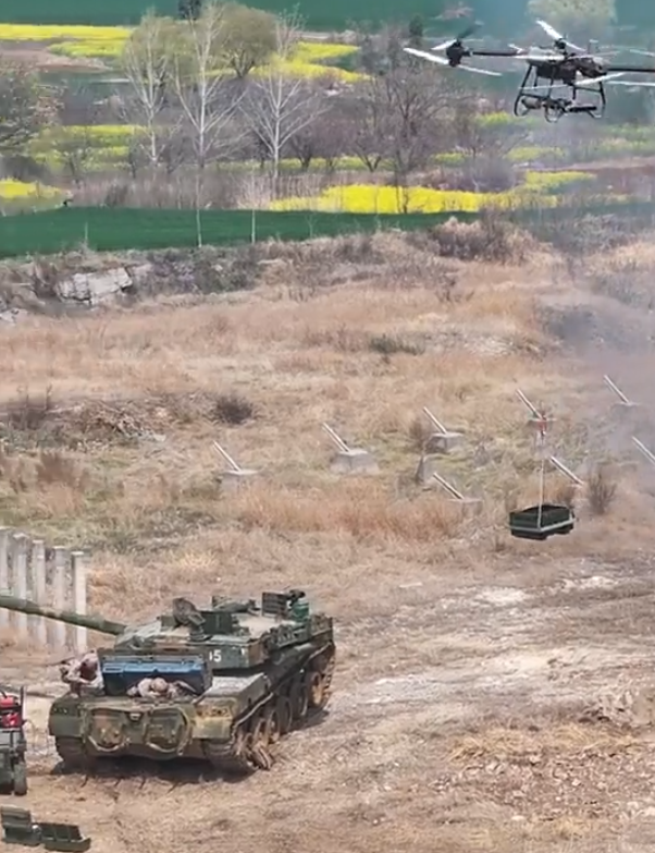 A drone delivering supplies to personnel repairing a PLAA 35th HCAB Type-96A main battle tank equipped with a GL-6 active protection system